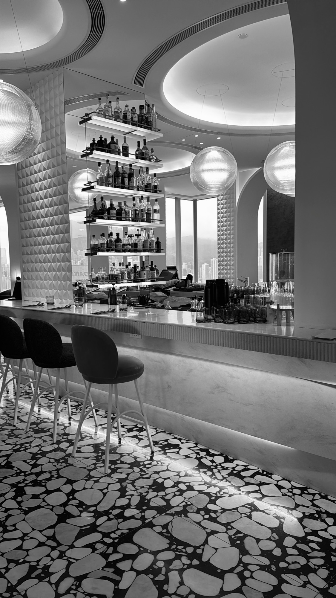 A high-end Abu Dhabi bar at dusk, the skyline beyond